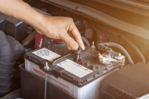 auto mechanic working check system water battery fill old car engine service station change repair before drive