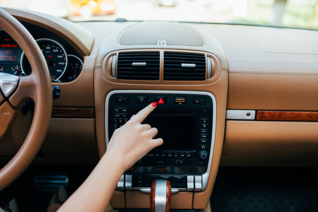 car dashboard radio closeup woman sets up radio